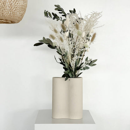 Perfect decoration: dried flower bouquet with olive branches in beige